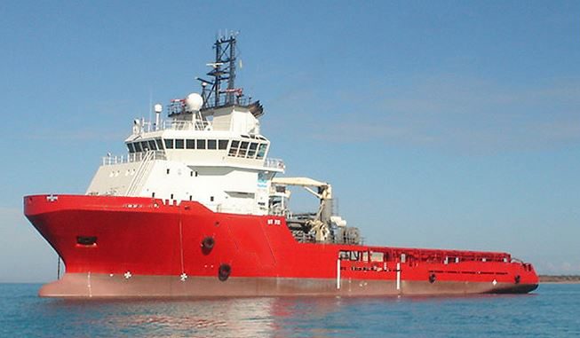 Red offshore support vessel at sea