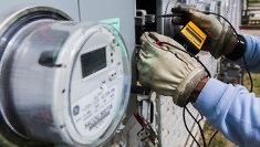 Technician installing and testing a smart meter